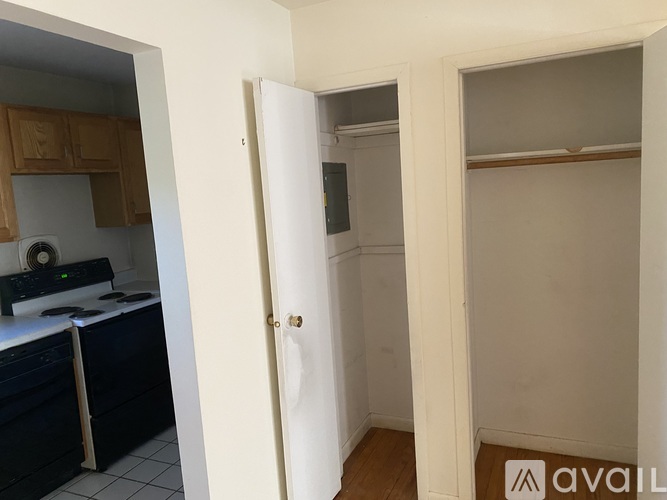 A kitchen with a white door and a black counter.
