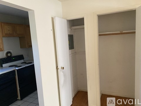 A kitchen with a white door and a black counter.