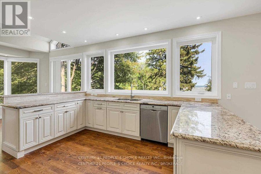 A kitchen with white cabinets and a granite countertop.