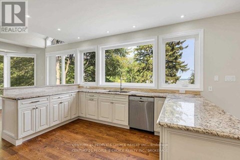 A kitchen with white cabinets and a granite countertop.