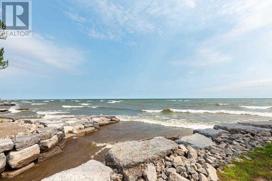 A rocky beach with waves crashing against the rocks.