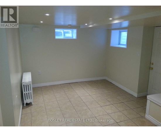 A room with a white radiator and tiled floor.