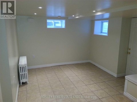 A room with a white radiator and tiled floor.