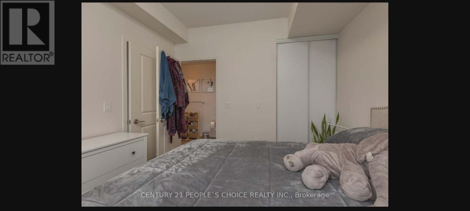 A bedroom with a bed, a dresser, and a closet.