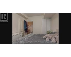 A bedroom with a bed, a dresser, and a closet.