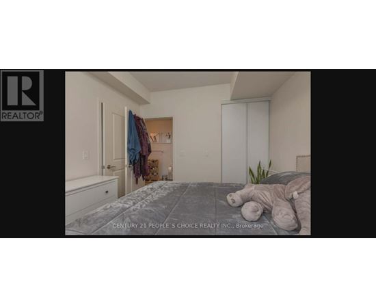 A bedroom with a bed, a dresser, and a closet.
