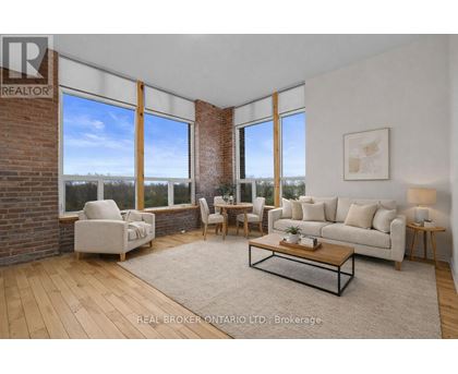 A living room with a couch, chairs, and a coffee table.
