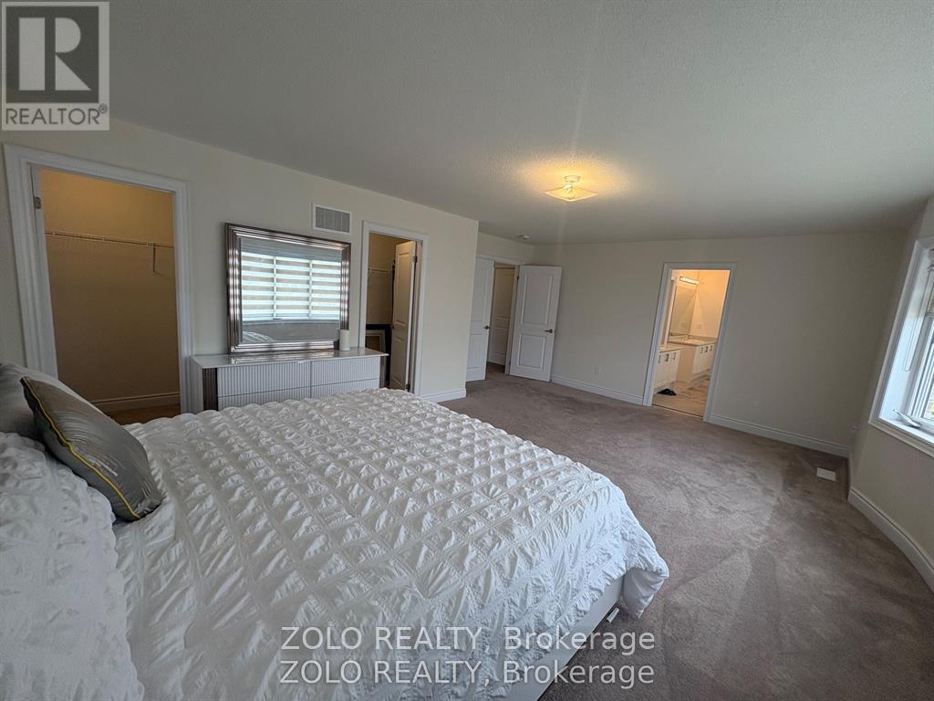 A bedroom with a large bed and a window with blinds.