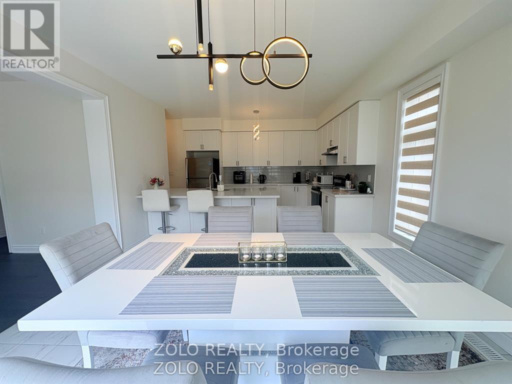 A modern kitchen with a dining table and chairs.