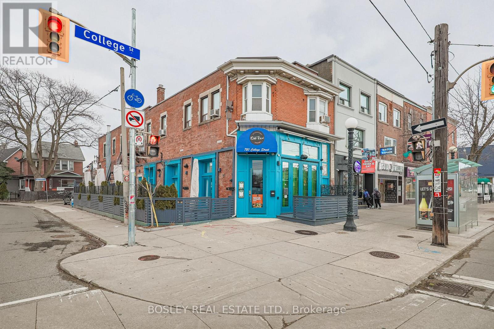 A street corner with a blue building and a sign that says College.