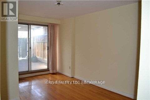 A room with a sliding glass door leading to a balcony.