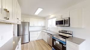 A kitchen with white cabinets and stainless steel appliances.