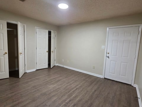 A room with white doors and a light on the ceiling.