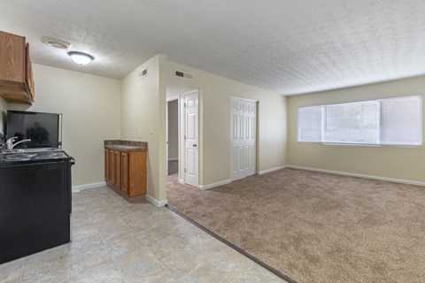 A spacious living room with a black countertop and a flat-screen TV.