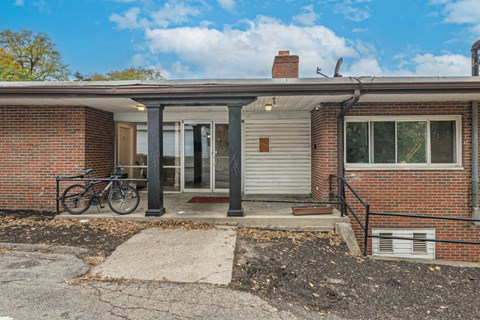 A brick house with a bicycle parked in front.