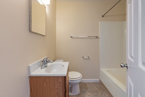 A bathroom with a sink, toilet, and bathtub.