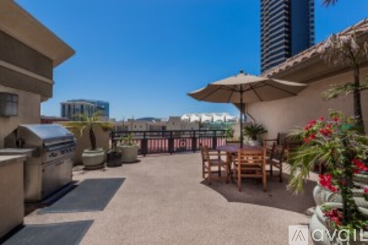 A patio with a table and chairs is set up on a balcony.