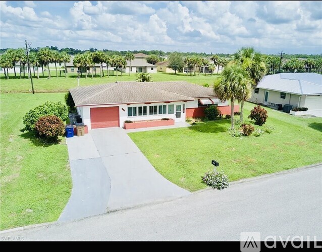 A house with a red garage door is for sale.