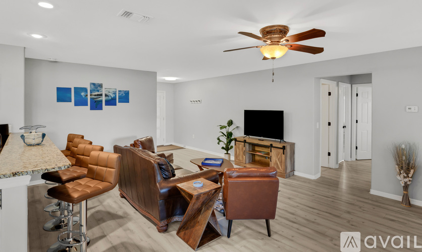 A living room with a brown leather chair and a wooden coffee table.