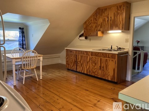 A kitchen with wooden cabinets and a white countertop.