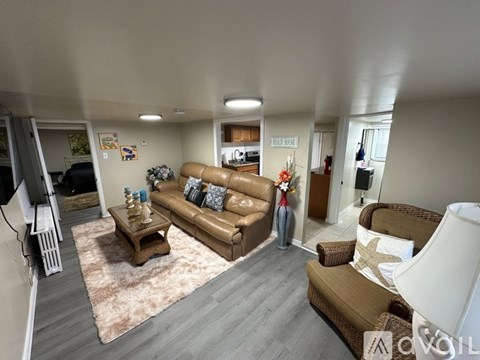 A living room with a brown couch and a coffee table.