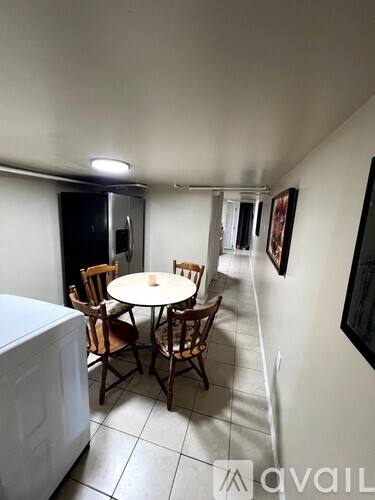 A dining room with a table and chairs.