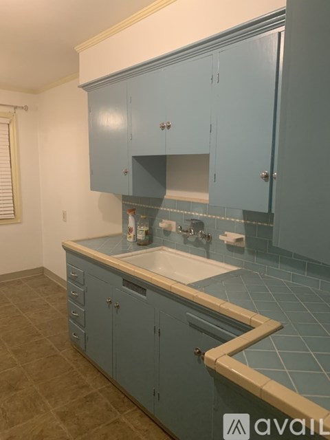 A kitchen with blue cabinets and a countertop.