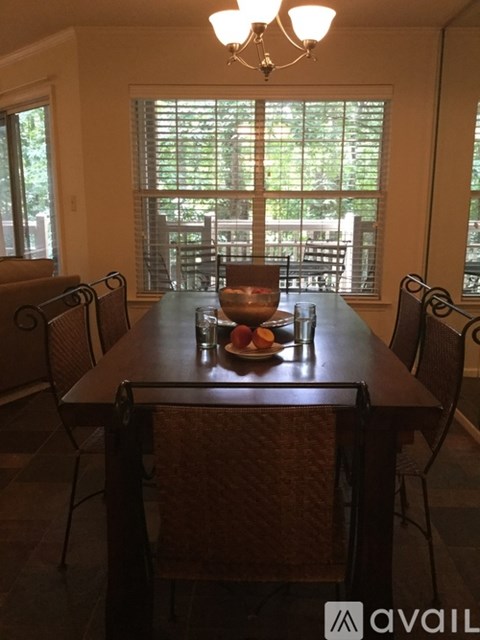 A dining room with a table set for a meal.