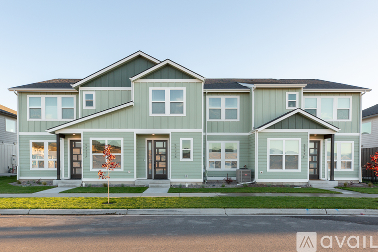 A row of houses with the first one for sale.