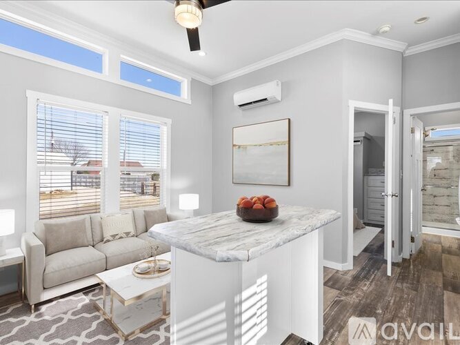 A modern living room with a marble island in the center.