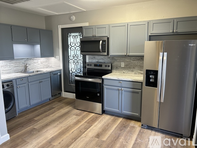A kitchen with a stainless steel refrigerator and oven.