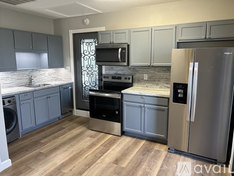 A kitchen with a stainless steel refrigerator and oven.