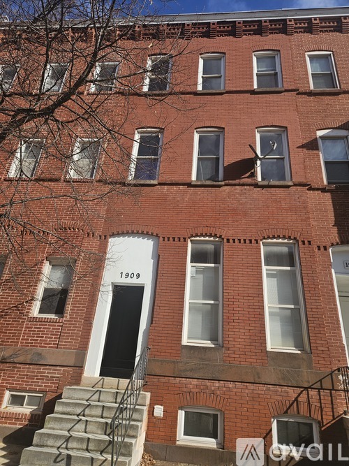 A red brick building with the number 1909 on the front door.