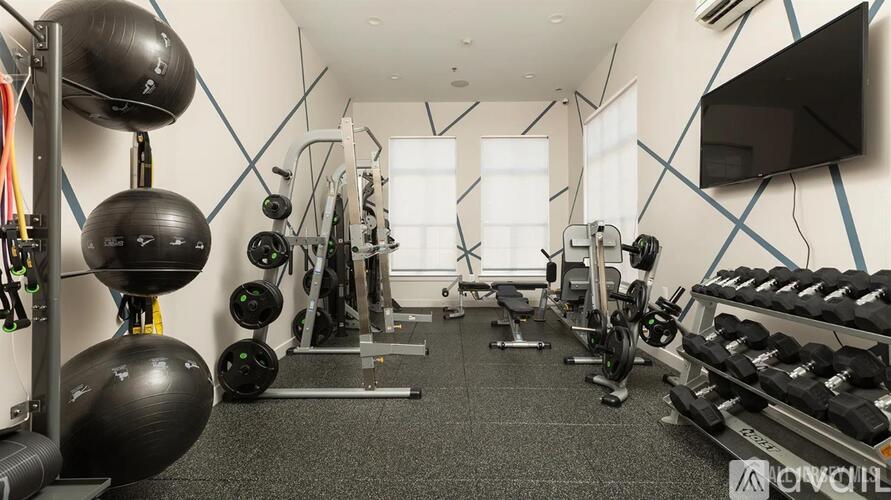 A well-equipped gym with various exercise machines and weights.