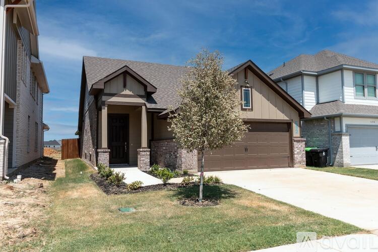 A house with a brown roof and a white garage door.
