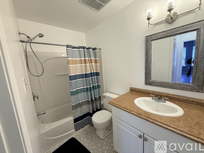 A bathroom with a sink, toilet, and bathtub.