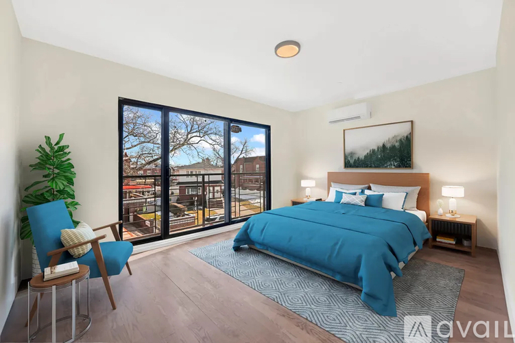 A bedroom with a large bed and a view of the city through the window.