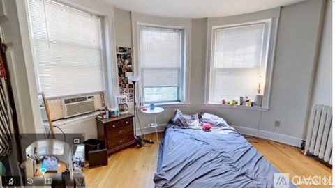A bedroom with a bed, dresser, and window.