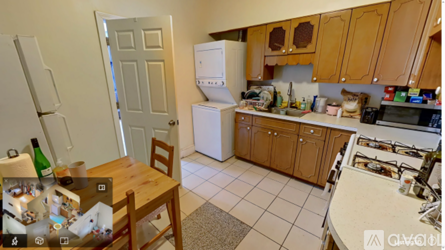 A kitchen with a refrigerator, microwave, and oven.
