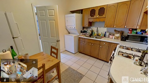 A kitchen with a refrigerator, microwave, and oven.