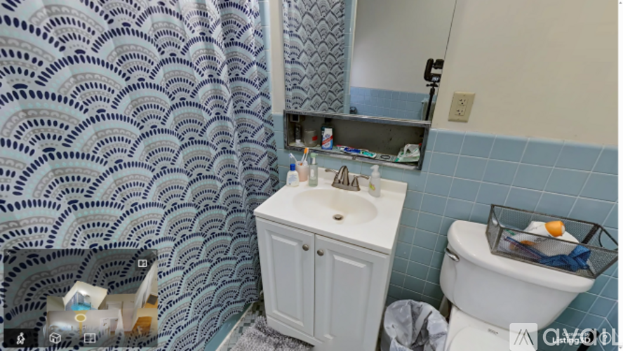 A bathroom with a white toilet and a white sink with a cabinet.