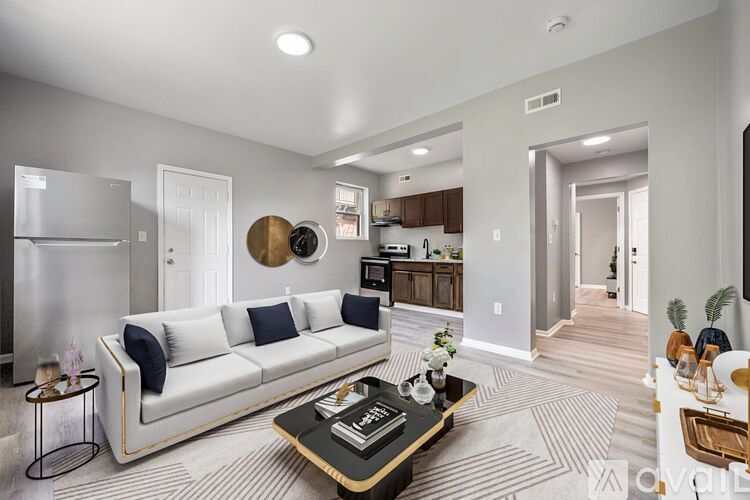 A modern living room with a white sofa and a coffee table.