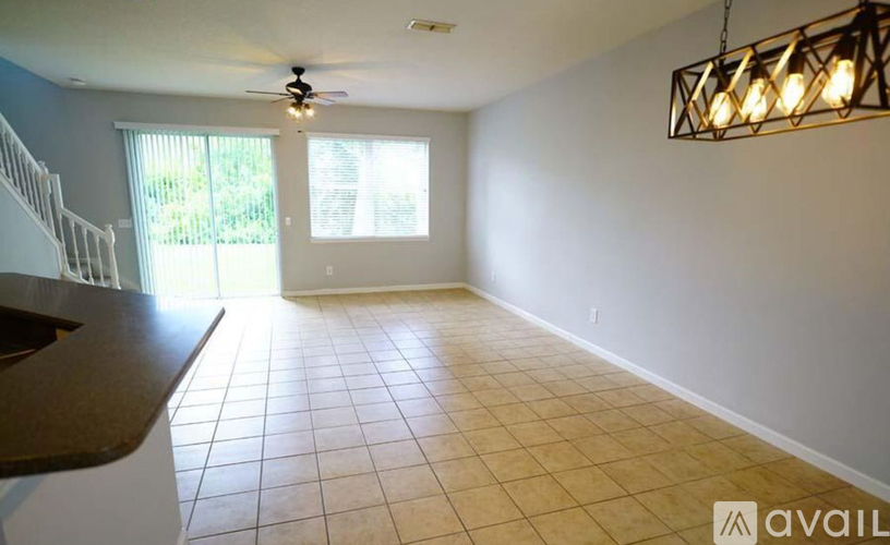 A room with a ceiling fan and a light fixture.