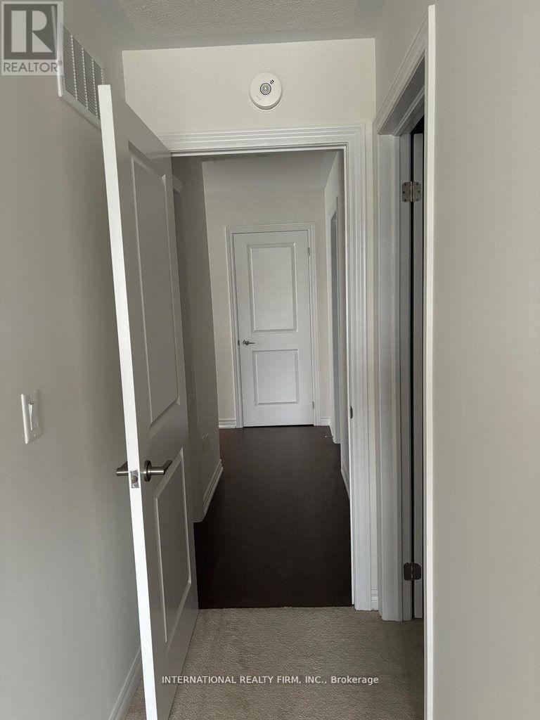 A hallway with a door at the end.