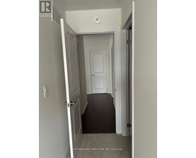 A hallway with a door at the end.