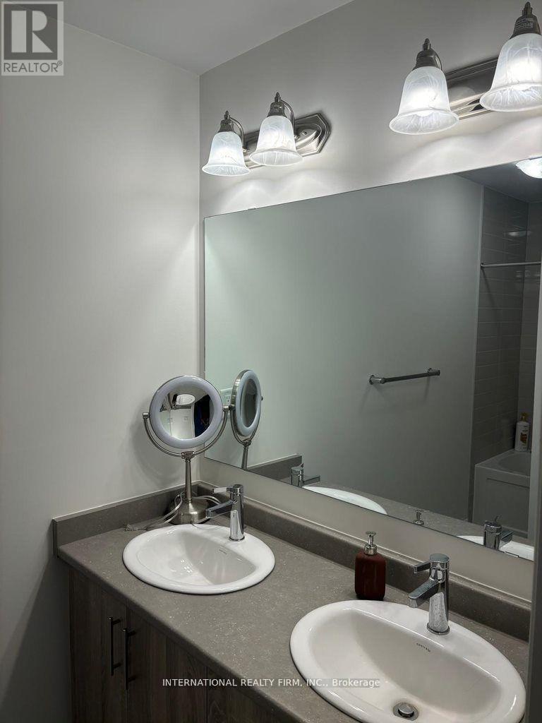 A bathroom with a sink, mirror, and lights.
