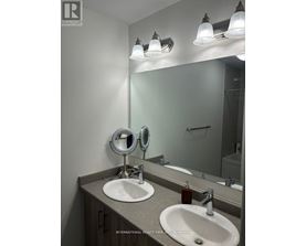 A bathroom with a sink, mirror, and lights.