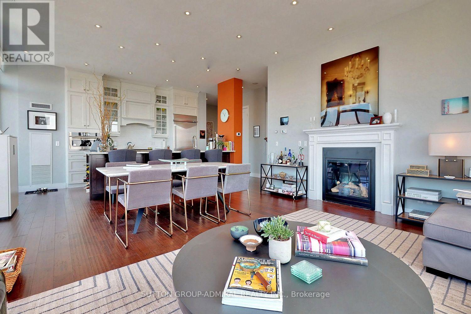 A modern living room with a fireplace and a dining table set up.