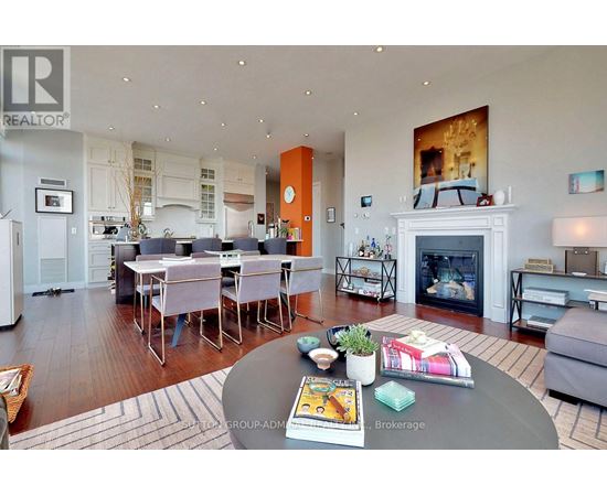 A modern living room with a fireplace and a dining table set up.