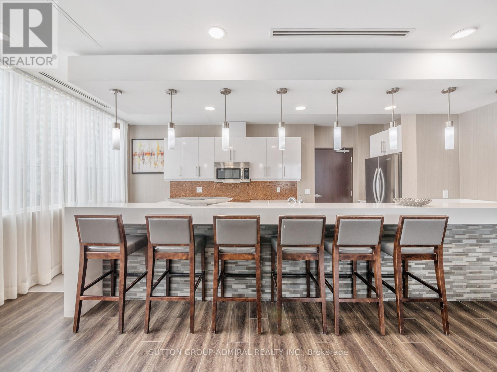 A modern kitchen with a dining table set for six.
